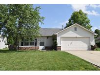 Charming single-story home with a well-maintained lawn and attached garage, offering comfortable suburban living at 1652 Sweetwater Ln, Greenfield, IN 46140