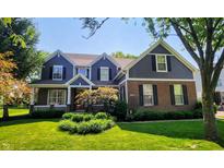 Charming two-story home featuring a manicured lawn, tasteful landscaping, and a welcoming front porch, perfect for suburban living at 17002 Folly Brook Rd, Noblesville, IN 46060