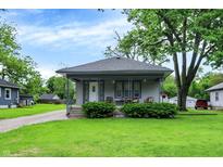 Charming home featuring a cozy front porch, well-manicured lawn, and inviting curb appeal at 2150 S Emerson Ave, Indianapolis, IN 46203