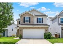 Inviting two-story home with stone accents, a two-car garage, and well-maintained landscaping at 2473 Shadow Bend Dr, Columbus, IN 47201