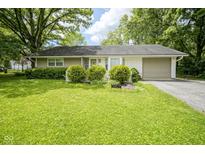 Charming single-story home with well-manicured lawn, mature trees, and an attached one-car garage at 2807 Westleigh Dr, Indianapolis, IN 46268