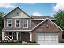 Charming two-story home featuring a brick and siding exterior with a two-car garage and well-maintained landscaping at 310 Atlas Dr, Lebanon, IN 46052