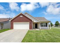 Charming single-Gathering home with brick facade, attached garage, and well-maintained lawn at 3222 Enclave Ln, Greenwood, IN 46143