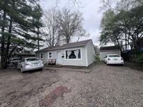 Cozy single-story home with neutral siding, simple landscaping, and a detached garage, offering a classic suburban charm at 4020 Patricia St, Indianapolis, IN 46222
