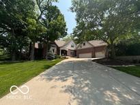 Charming brick home with a long driveway and mature trees at 4037 Oakleaf Dr, Zionsville, IN 46077
