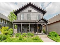 Charming two-story home featuring a covered front porch and beautifully landscaped yard at 584 S 10Th St, Noblesville, IN 46060