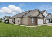 Charming single-Gathering home with a well-manicured lawn and an attached two-car garage at 608 Fisher Creek Dr, Indianapolis, IN 46239