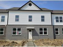 New two-story home featuring a brick and siding exterior with black trim details and a welcoming front door at 6162 Cascades Dr, Whitestown, IN 46075