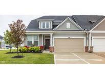 Charming home featuring neutral siding, an attached garage, and a welcoming front porch at 747 Tuxedo Dr, Westfield, IN 46074