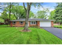 Charming single-story brick home featuring a well-maintained lawn and attached garage at 820 S Eaglewood Dr, Zionsville, IN 46077