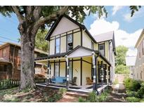Charming two-story home boasts a welcoming front porch and beautifully maintained landscaping at 847 N Park Ave, Indianapolis, IN 46202