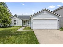 Charming single-story home with a two-car garage, well-maintained lawn, and welcoming curb appeal at 9560 W Campfire Dr, Pendleton, IN 46064
