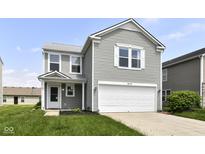 Charming two-story home with a two-car garage, light gray siding, and a well-maintained front lawn at 9676 W Constellation Dr, Pendleton, IN 46064