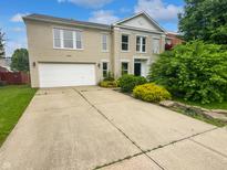 Charming two-story home with a two-car garage and driveway enhanced by manicured landscaping at 10366 Camby Xing, Fishers, IN 46038