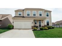 Inviting two-story home with a spacious two-car garage and well-manicured front lawn at 10447 Pintail Ln, Indianapolis, IN 46239