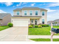Charming two-story home featuring a well-manicured lawn, attached garage, and welcoming front porch at 10447 Pintail Ln, Indianapolis, IN 46239