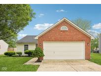 Charming home with a two-car garage featuring a brick facade and well-maintained landscaping at 1093 Country Meadow Ct, Franklin, IN 46131