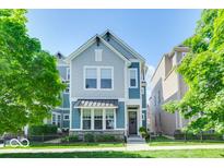 Charming home showcasing its quaint architecture, well-maintained landscaping, and inviting entrance under a bright, sunny sky at 13217 E 131St St, Fishers, IN 46037