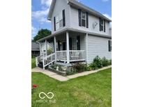 Charming two-story home with inviting front porch and tidy landscaping at 1517 S Reisner St, Indianapolis, IN 46221