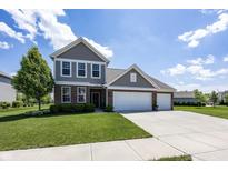 Charming two-story home with a well-manicured lawn, brick accents, and a three-car garage at 16419 Connolly Dr, Westfield, IN 46074