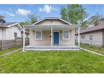 Charming single-story home with a welcoming front porch and a well-maintained lawn at 2030 Houston St, Indianapolis, IN 46218