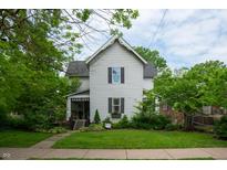 Charming two-story home with a landscaped front yard and inviting porch at 232 S Audubon Rd, Indianapolis, IN 46219