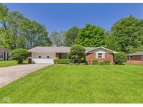 Charming brick ranch home with a well-manicured lawn and two-car garage at 25 N Mustin Dr, Anderson, IN 46012