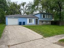Charming blue two-story home with a driveway and a well-maintained front lawn at 3628 Breen Dr, Indianapolis, IN 46235