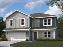 Charming two-story home featuring gray and blue siding and brick accents, complete with an attached two-car garage at 6031 Madera Dr, Whitestown, IN 46075