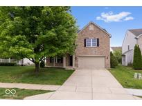Charming brick two-story home featuring a two-car garage and a well-manicured front yard at 6528 Abby Ln, Zionsville, IN 46077