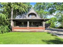 Charming craftsman-style home with a large front porch, updated brickwork, and lush lawn at 710 N Spring St, Greenfield, IN 46140