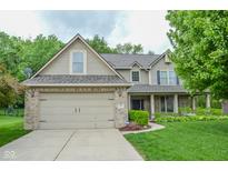 Charming two-story home features a brick-accented garage, manicured lawn, and welcoming curb appeal at 7322 Stones River Dr, Indianapolis, IN 46259