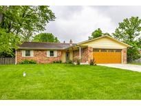 Charming single-story brick home featuring a well-maintained lawn and an attached two-car garage at 7580 Sherry Ln, Brownsburg, IN 46112