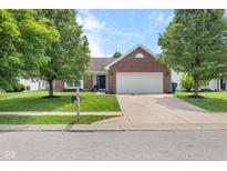 Charming brick home with a two-car garage, a well-manicured lawn, and mature trees in a quiet neighborhood at 11209 Black Gold Dr, Noblesville, IN 46060