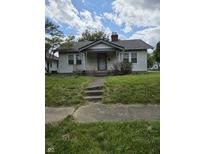 Quaint single-story house with a small front porch and a grassy front yard at 1168 N Gladstone Ave, Indianapolis, IN 46201