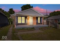 Charming bungalow with brick facade, gray siding, and welcoming front porch at 1170 N Concord St, Indianapolis, IN 46222