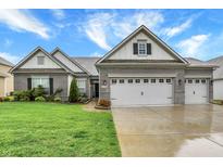 Charming single-Gathering home with a brick facade, well-manicured lawn, and a spacious three-car garage at 1334 Sunnybrook Ln, Greenwood, IN 46143