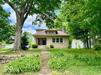 Charming stone home with a well-maintained front yard and mature trees at 1920 E Epler E Ave, Indianapolis, IN 46227