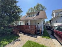 Charming two-story home featuring a quaint front porch and landscaped front yard at 254 N Mount St, Indianapolis, IN 46222