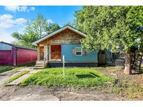 Charming single-story home with blue siding and wood shingle accents; great curb appeal at 3109 E St Joseph St, Indianapolis, IN 46201