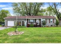 Charming ranch home with an attached garage and beautiful, green front yard at 3552 N Talley Rd, Columbus, IN 47203