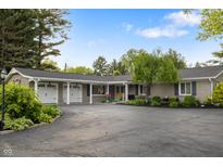 Ranch style home with beautiful landscaping and attached three car garage at 3904 Haverhill Dr, Indianapolis, IN 46240
