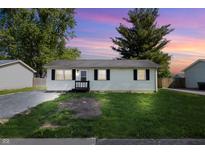 Charming single-story home featuring well-maintained landscaping and neutral siding at 410 W Douglas St, Martinsville, IN 46151