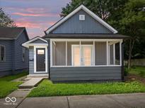 Charming home with a cozy screened-in front porch and well-maintained lawn at 429 Colescott St, Shelbyville, IN 46176