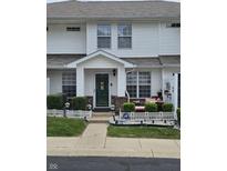 Charming two-story townhouse with well-maintained lawn, landscaping, and front porch decor at 4962 Potomac Square Pl, Indianapolis, IN 46268