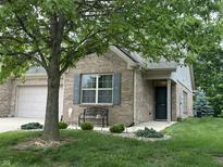 Charming brick home with tidy landscaping, and a convenient attached garage at 5486 Lipizzan Ln, Plainfield, IN 46168