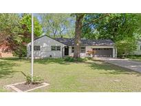 Charming single-story home featuring a well-maintained lawn and beautiful mature trees at 5843 N Oakland Ave, Indianapolis, IN 46220