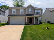 Two-story home with gray siding, a brick-accented garage, and a well-manicured front lawn at 6715 Shanghai Cir, Indianapolis, IN 46278