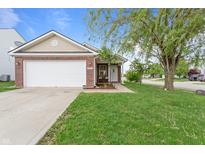 Charming home featuring a well-manicured lawn, attached garage, and inviting front porch at 805 Sunvista Dr, Avon, IN 46123