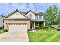 Charming two-story home with brick and siding, a well-manicured lawn and lovely flower beds at 938 Weeping Way Ln, Avon, IN 46123